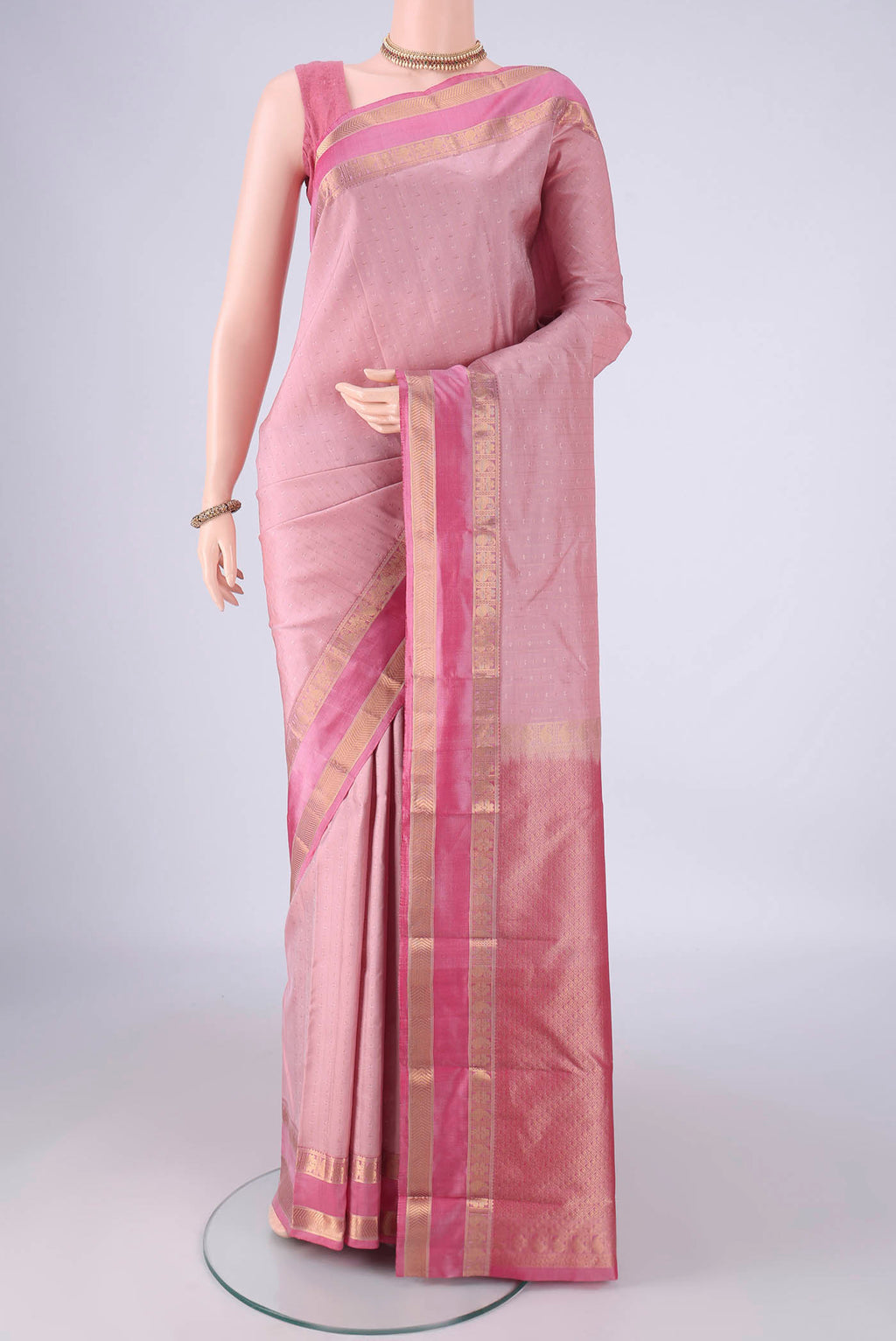 Rose Gold Kanchipuram Silk Saree with Zari Butta on the body and Zari Border.  displayed on a mannequin