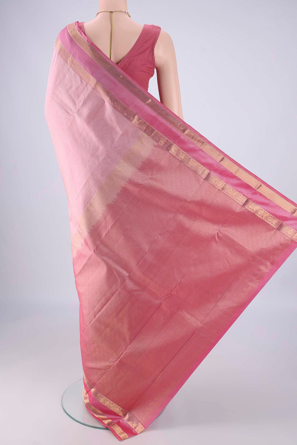 Flat view of Rose Gold Kanchipuram Silk Saree with Zari Butta on the body and Zari Border. 