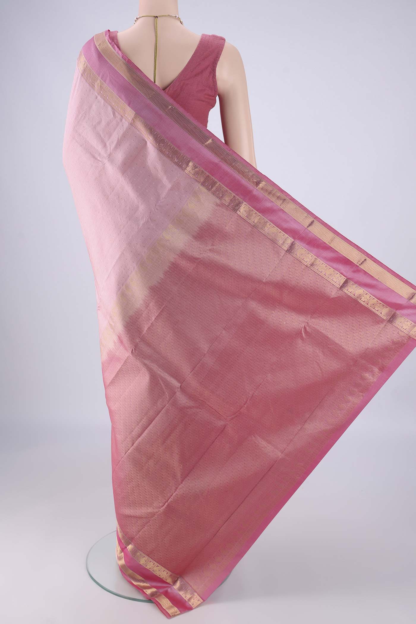 Flat view of Rose Gold Kanchipuram Silk Saree with Zari Butta on the body and Zari Border. 