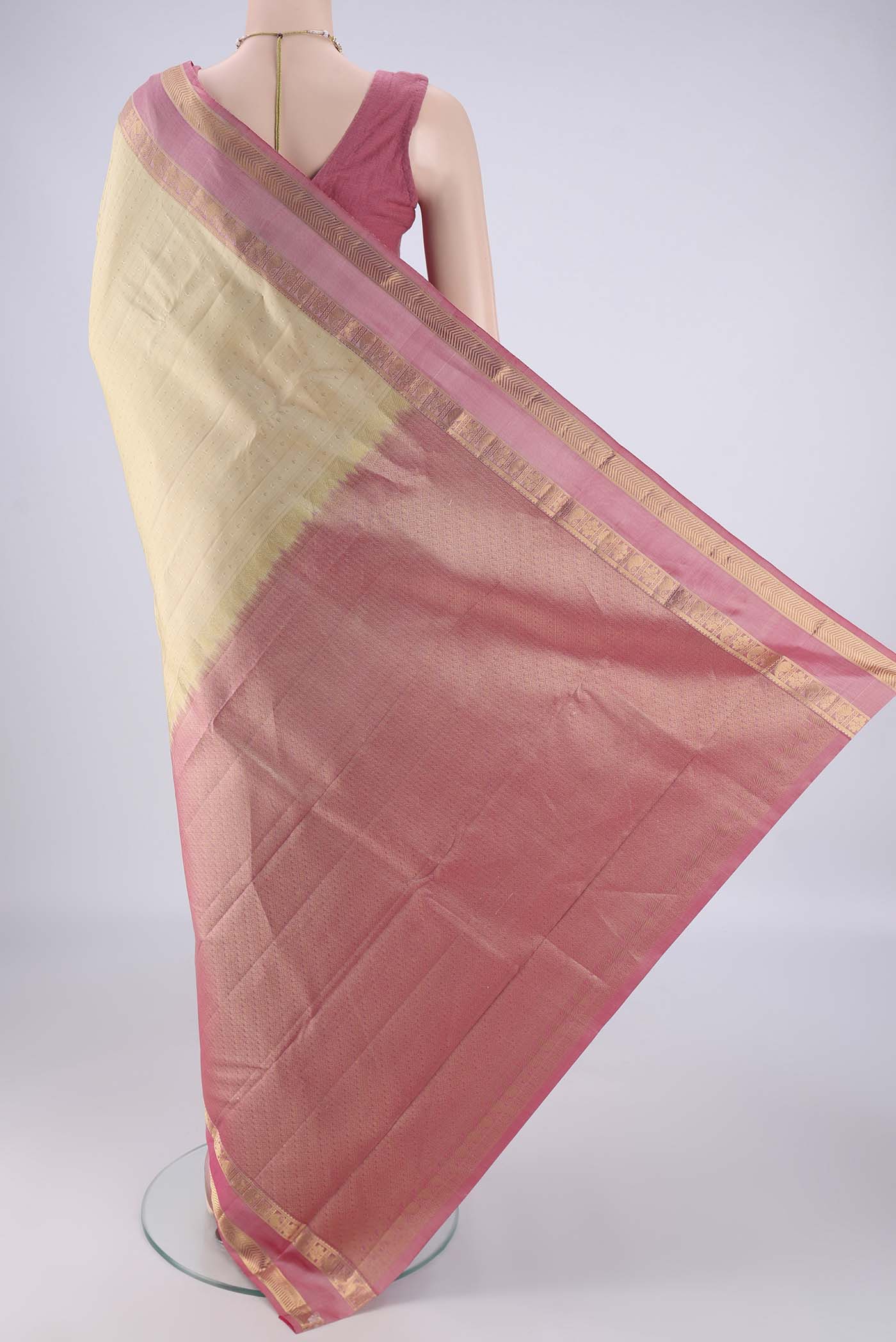 Flat view of Cream Kanchipuram Silk Saree with Zari Butta on the body and Zari Border. 
