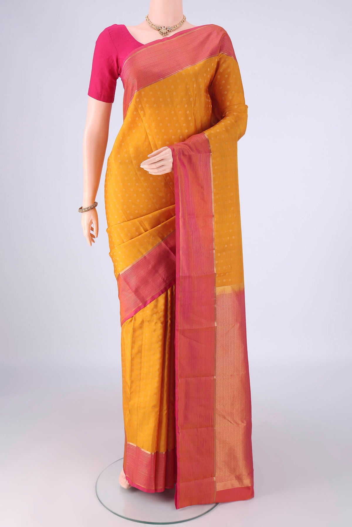 Yellow Kanchipuram Silk Saree with Zari Butta on the body and Plain Border.  displayed on a mannequin