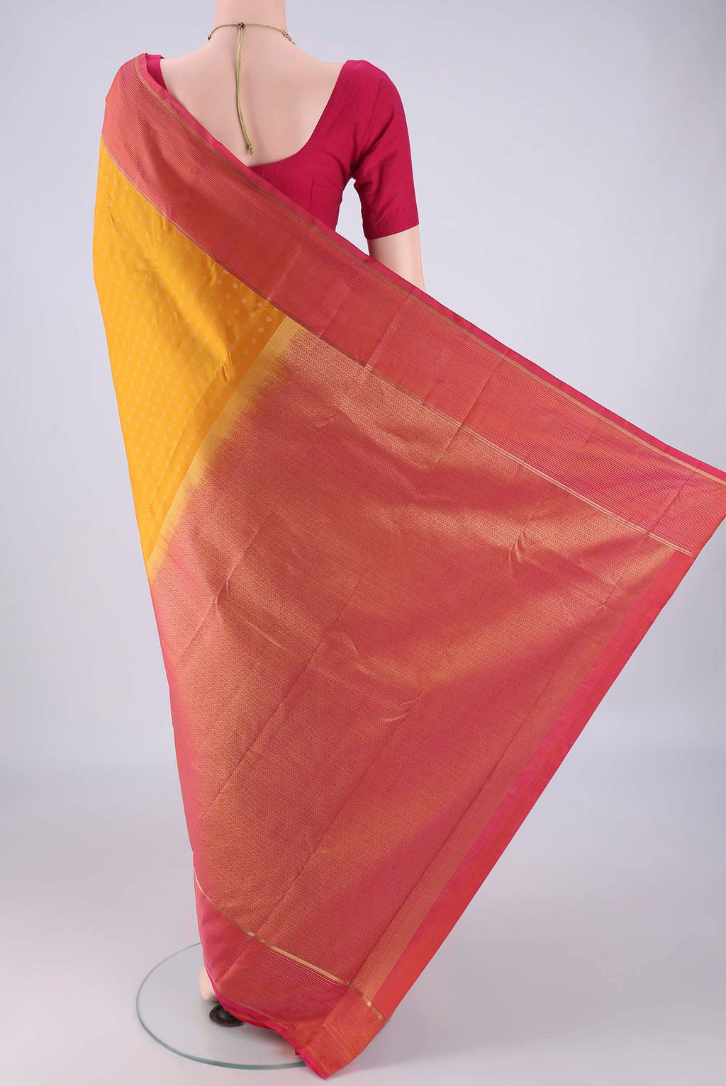 Flat view of Yellow Kanchipuram Silk Saree with Zari Butta on the body and Plain Border. 