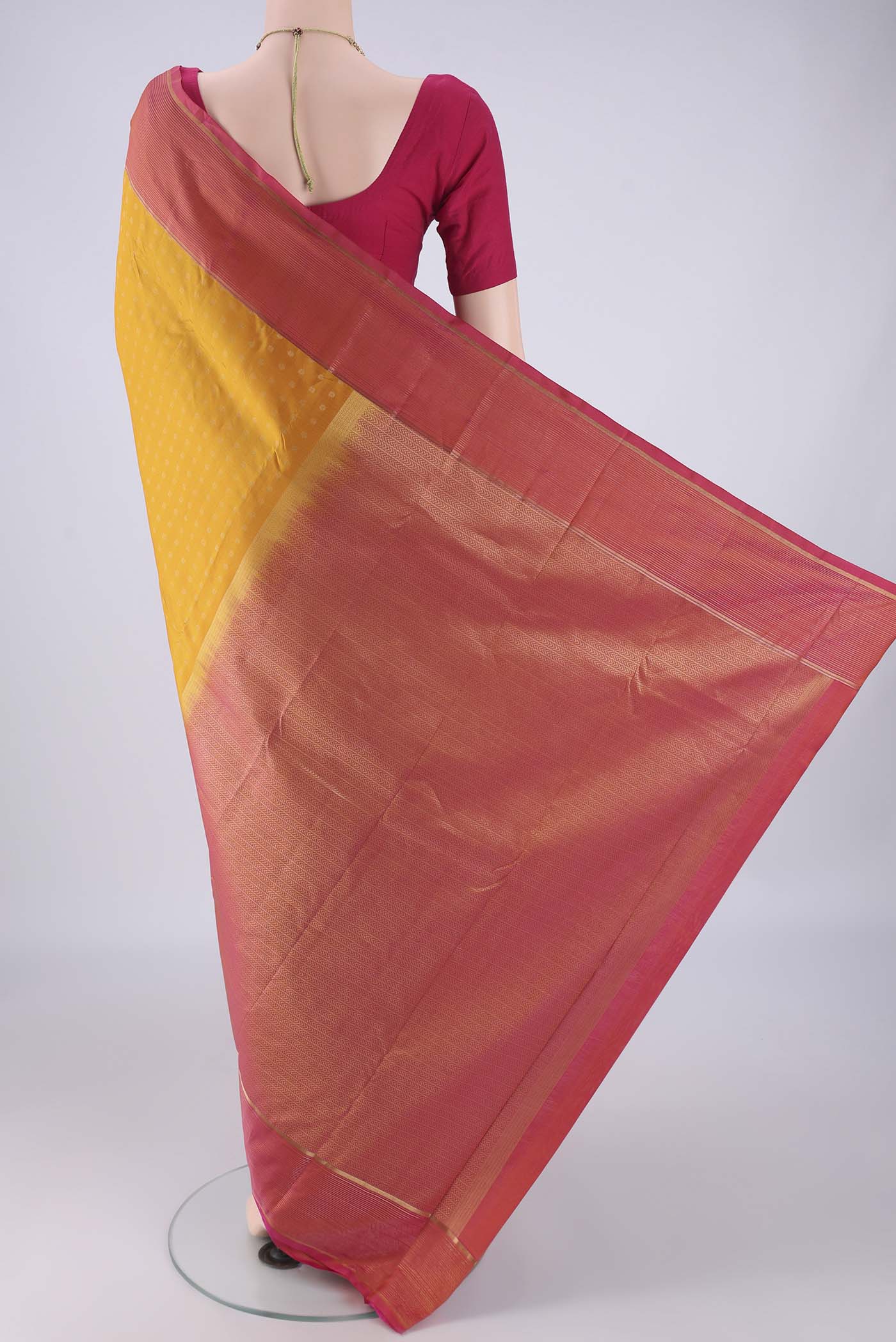 Flat view of Yellow Kanchipuram Silk Saree with Zari Butta on the body and Plain Border. 