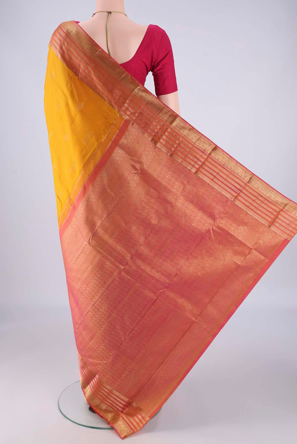 Flat view of Yellow Kanchipuram Silk Saree with Zari Butta on the body and Zari Border. 