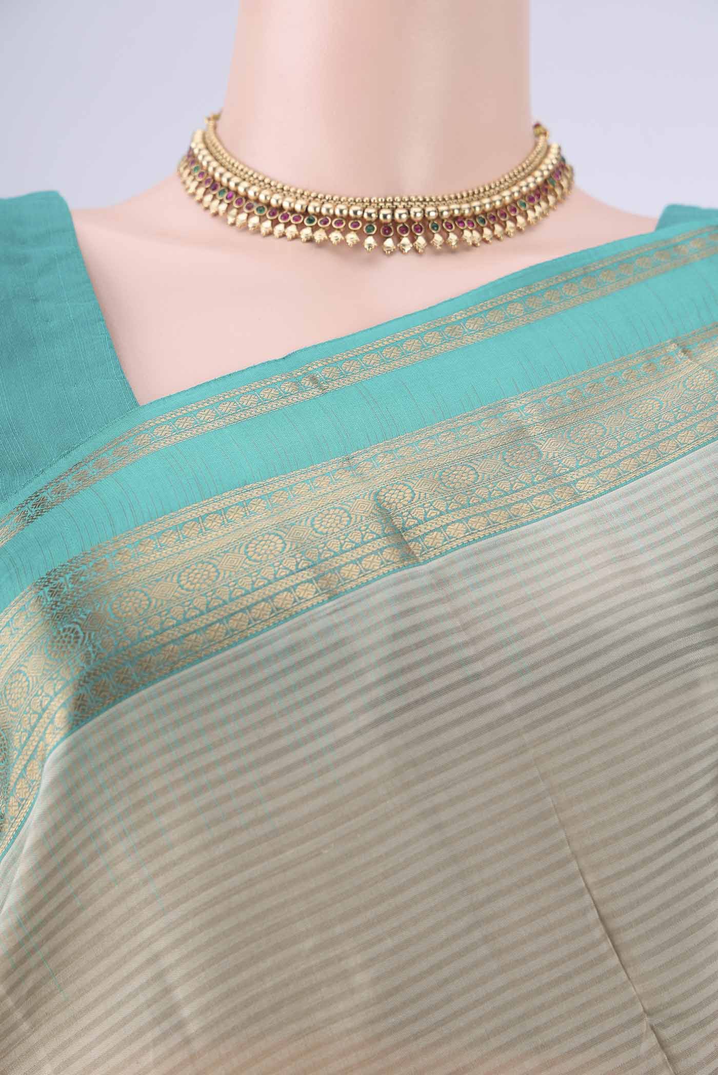 Border image of Beige Kanchipuram Silk Saree with Stripes on the body and Zari Border. 