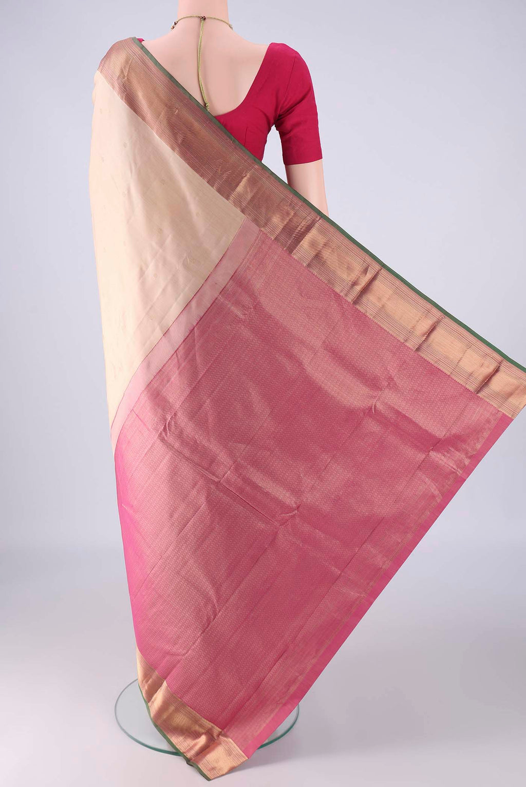 Flat view of Beige Kanchipuram Silk Saree with Zari Butta on the body and Zari Border. 