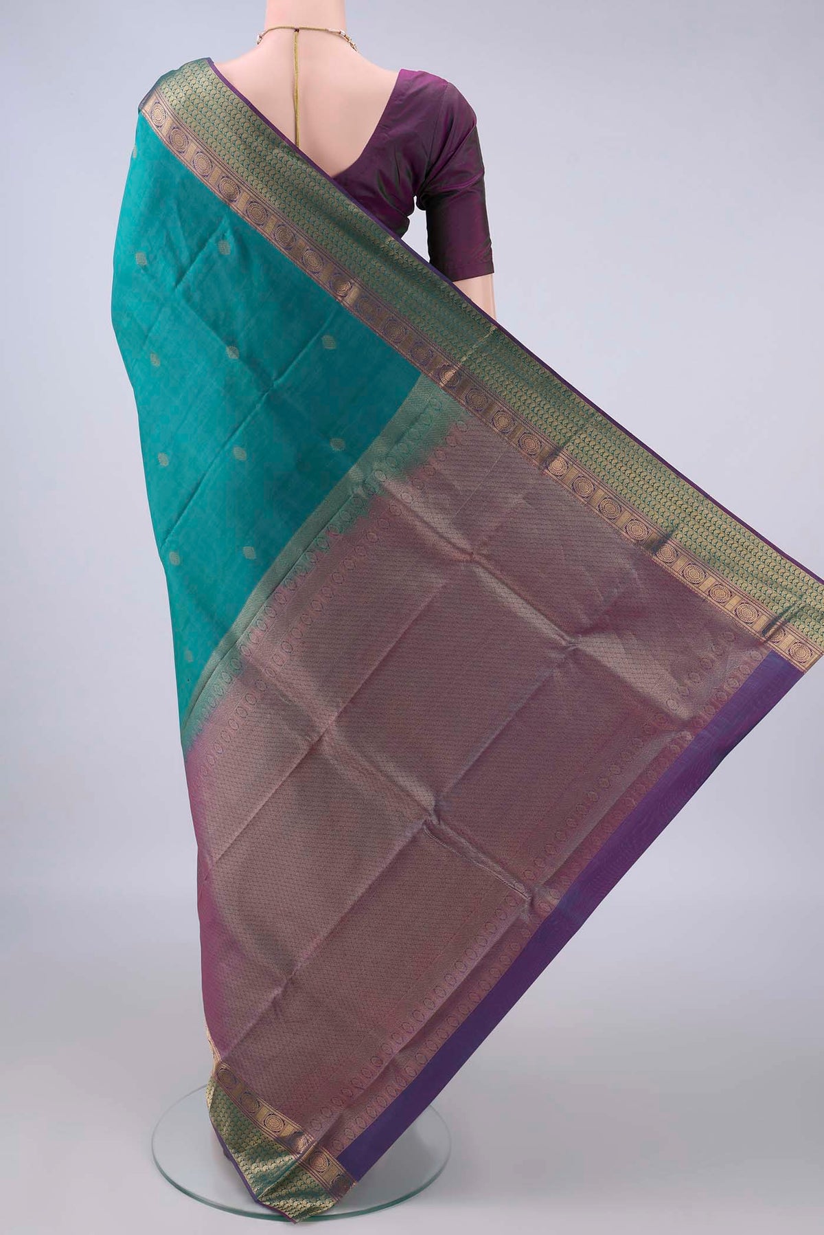 Flat view of Pure Silk Sea Green Kanchipuram Saree with Zari Butta on the body and Zari Border. 