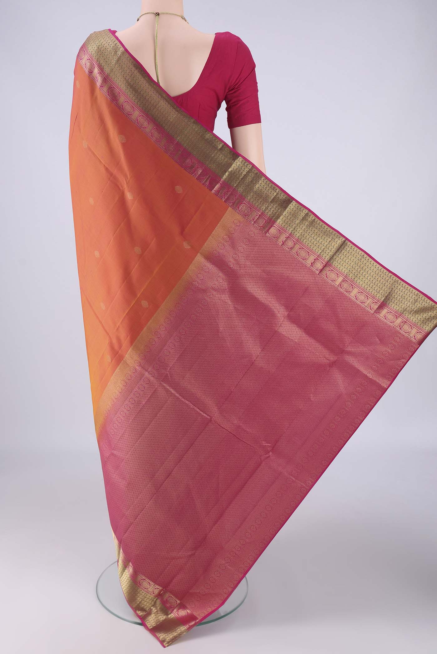 Flat view of Brick Orange Kanchipuram Silk Saree with Zari Butta on the body and Zari Border. 