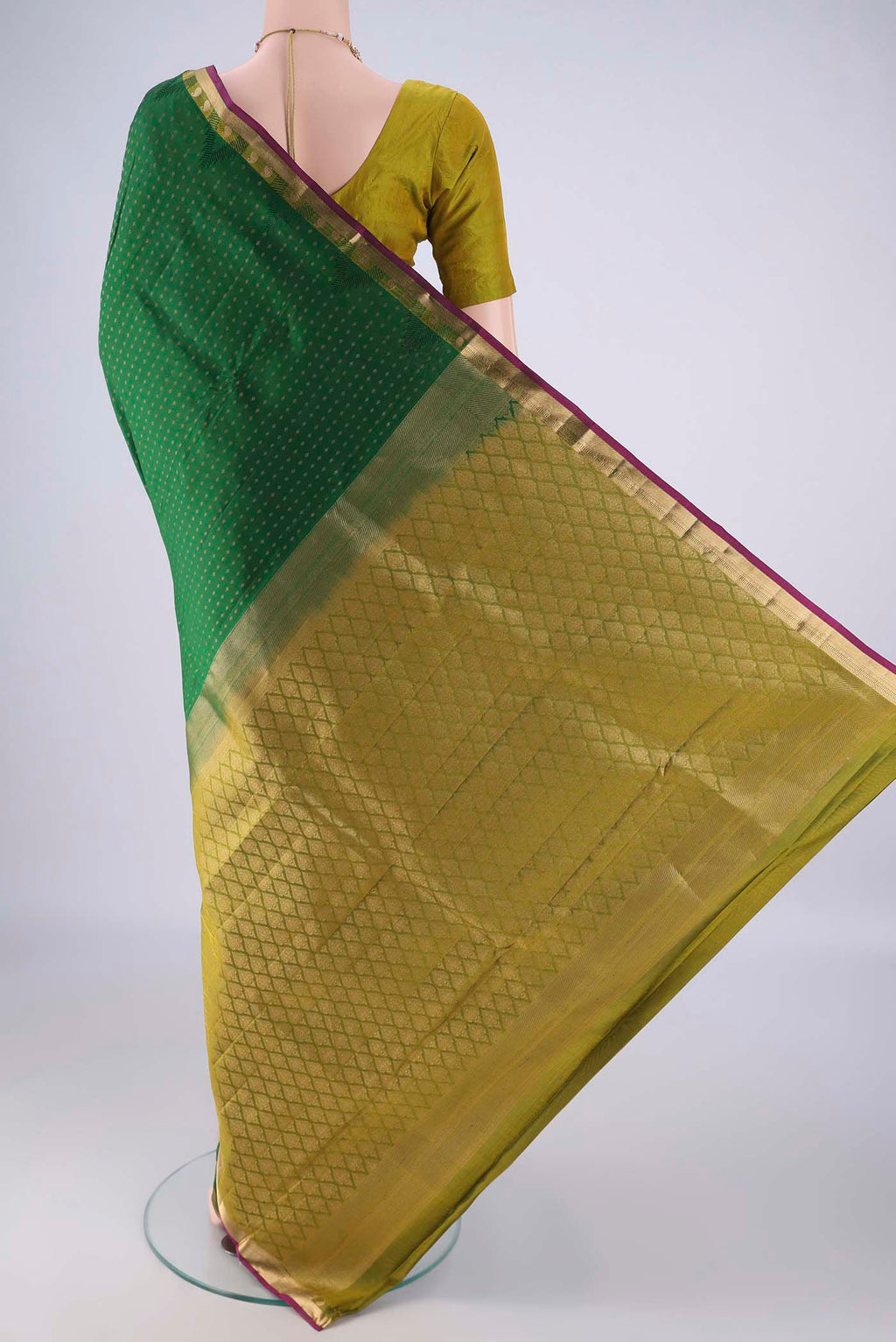 Flat view of Bottle Green Kanchipuram Silk Saree with Zari Butta on the body and Zari Border. 