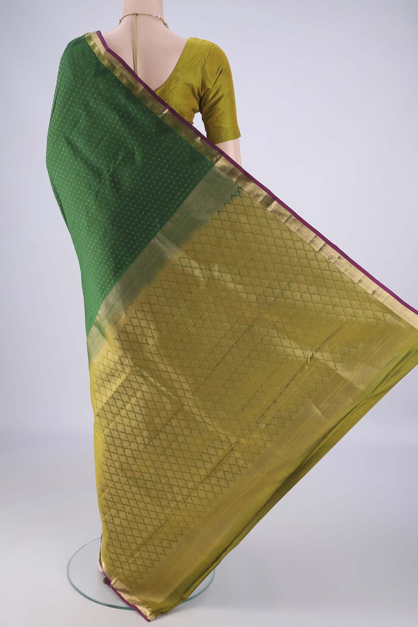 Flat view of Bottle Green Kanchipuram Silk Saree with Zari Butta on the body and Zari Border. 