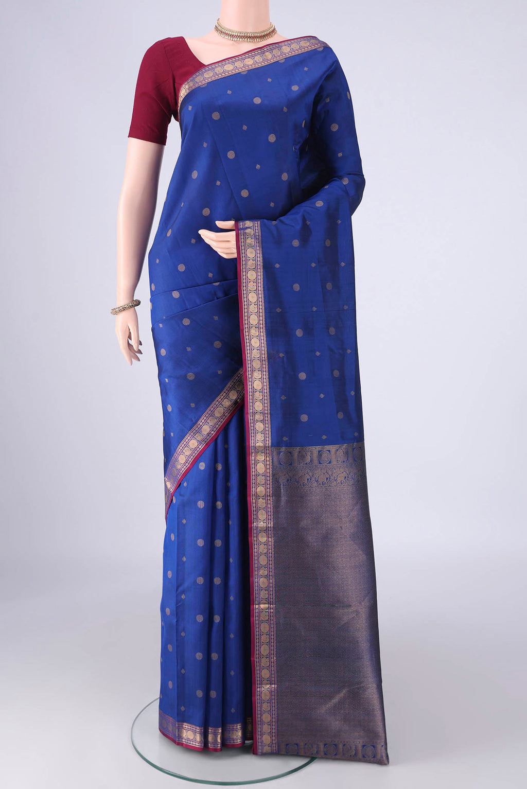Dark Blue Kanchipuram Silk Saree with Zari Butta on the body and Zari Border.  displayed on a mannequin