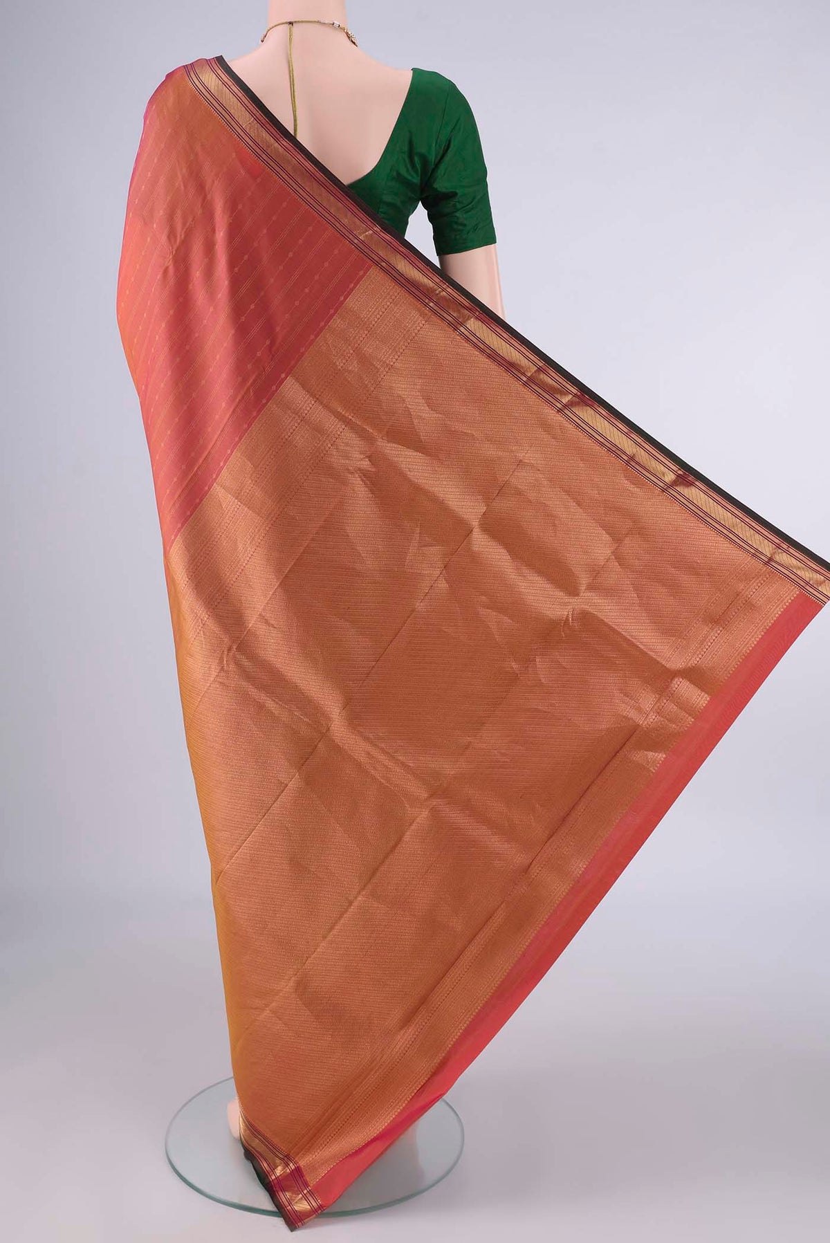 Flat view of Pure Silk Brick Orange Kanchipuram Saree with Stripes on the body and Zari Border. 