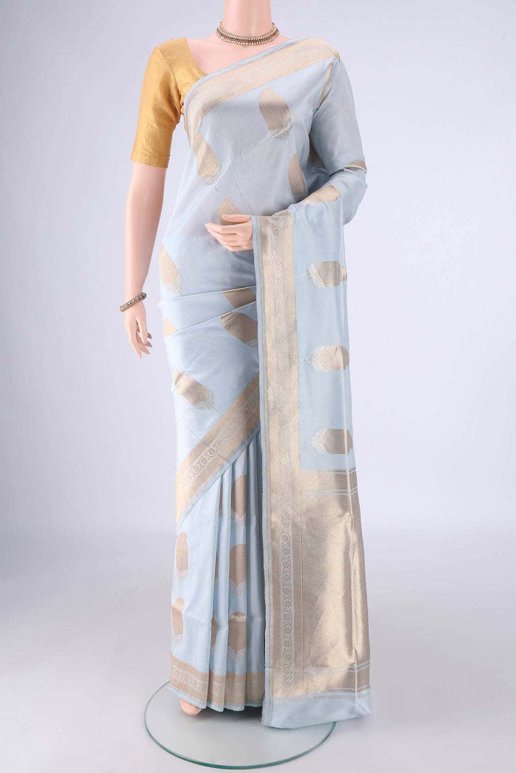 Sky Blue Banarasi Silk Saree with Zari Butta on the body and Zari Border.  displayed on a mannequin