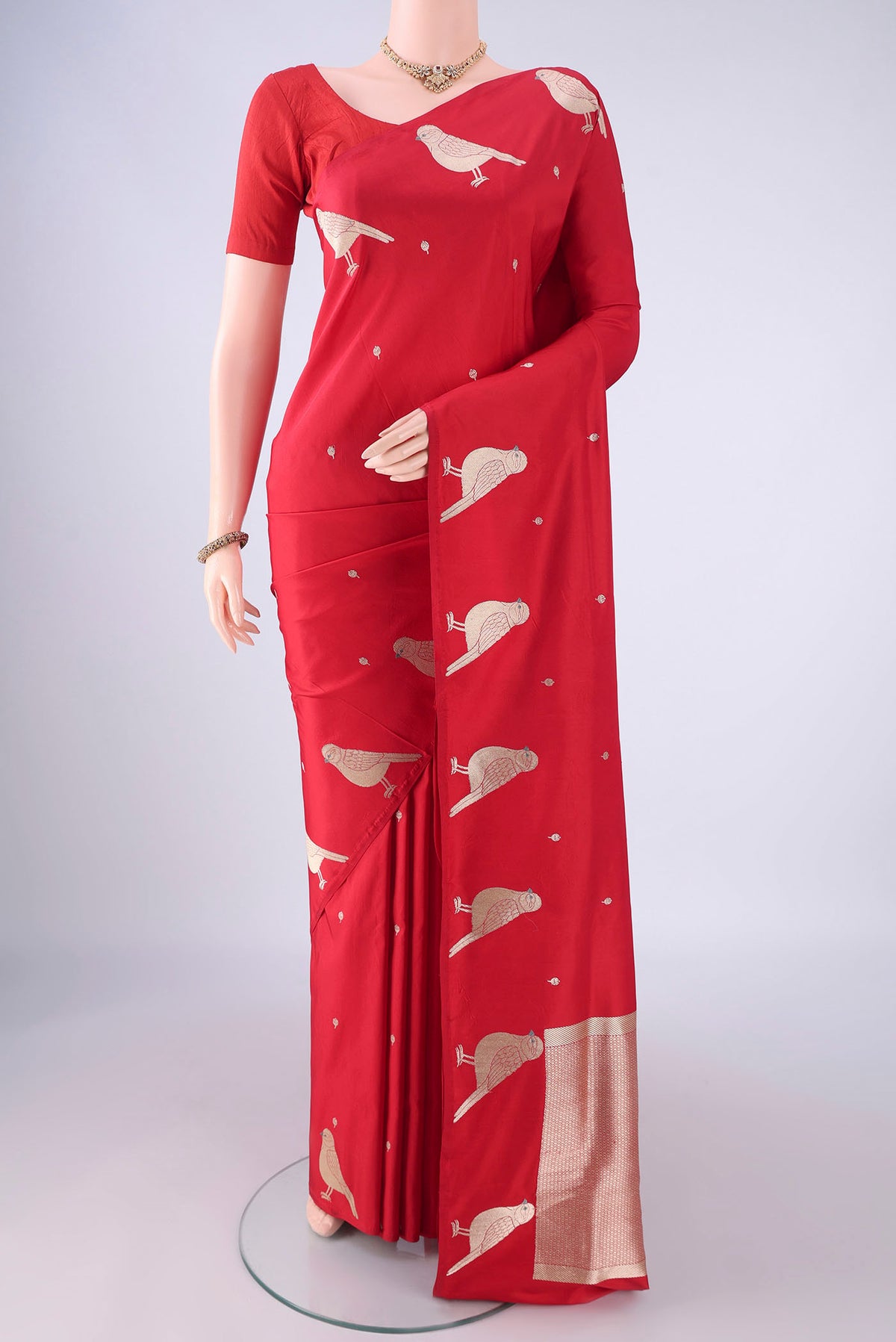 Red Banarasi Silk Saree with Zari Butta on the body and Zari Border.  displayed on a mannequin