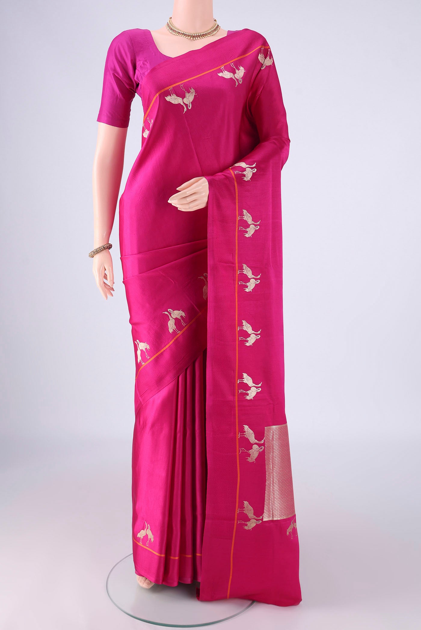 Rani Pink Banarasi Silk Saree with Plain Body and Zari Border.  displayed on a mannequin