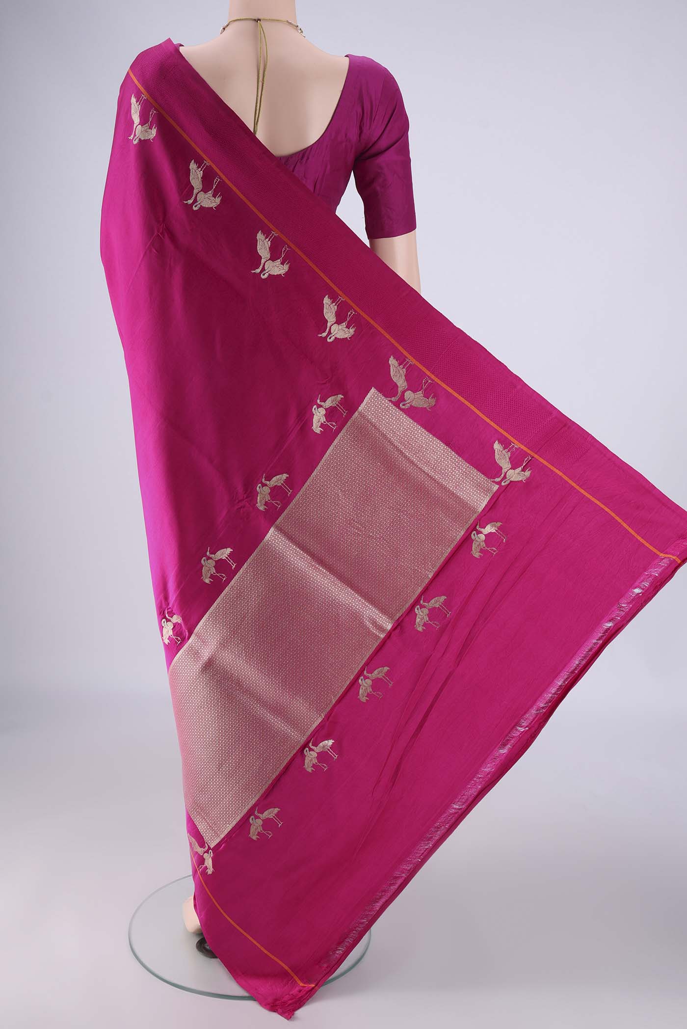 Flat view of Rani Pink Banarasi Silk Saree with Plain Body and Zari Border. 