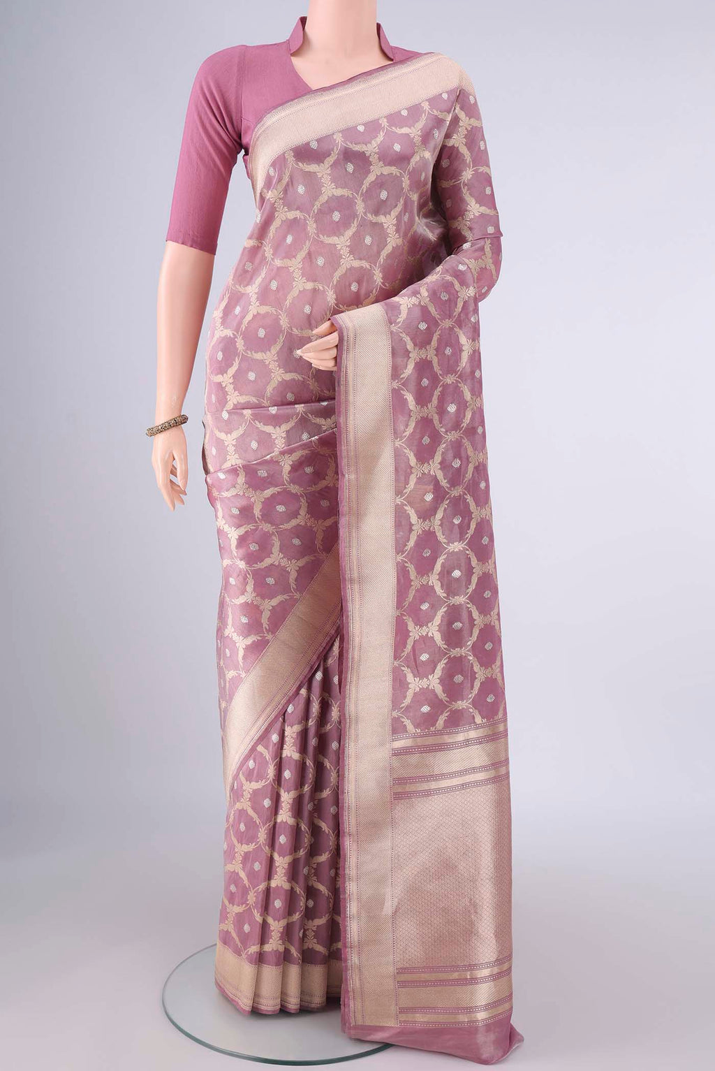 Mauve Banarasi Saree with Zari Brocade on the body and Zari Border.  displayed on a mannequin