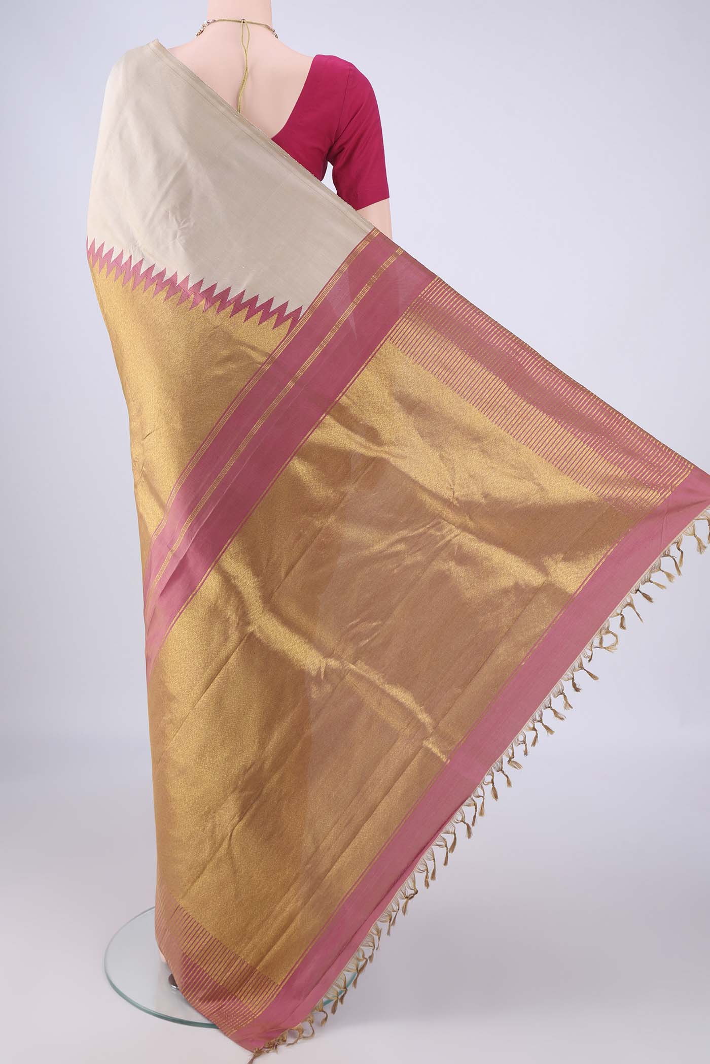 Flat view of Beige Kanjivaram Silk Saree with Plain Body and Rising Temple Border. 