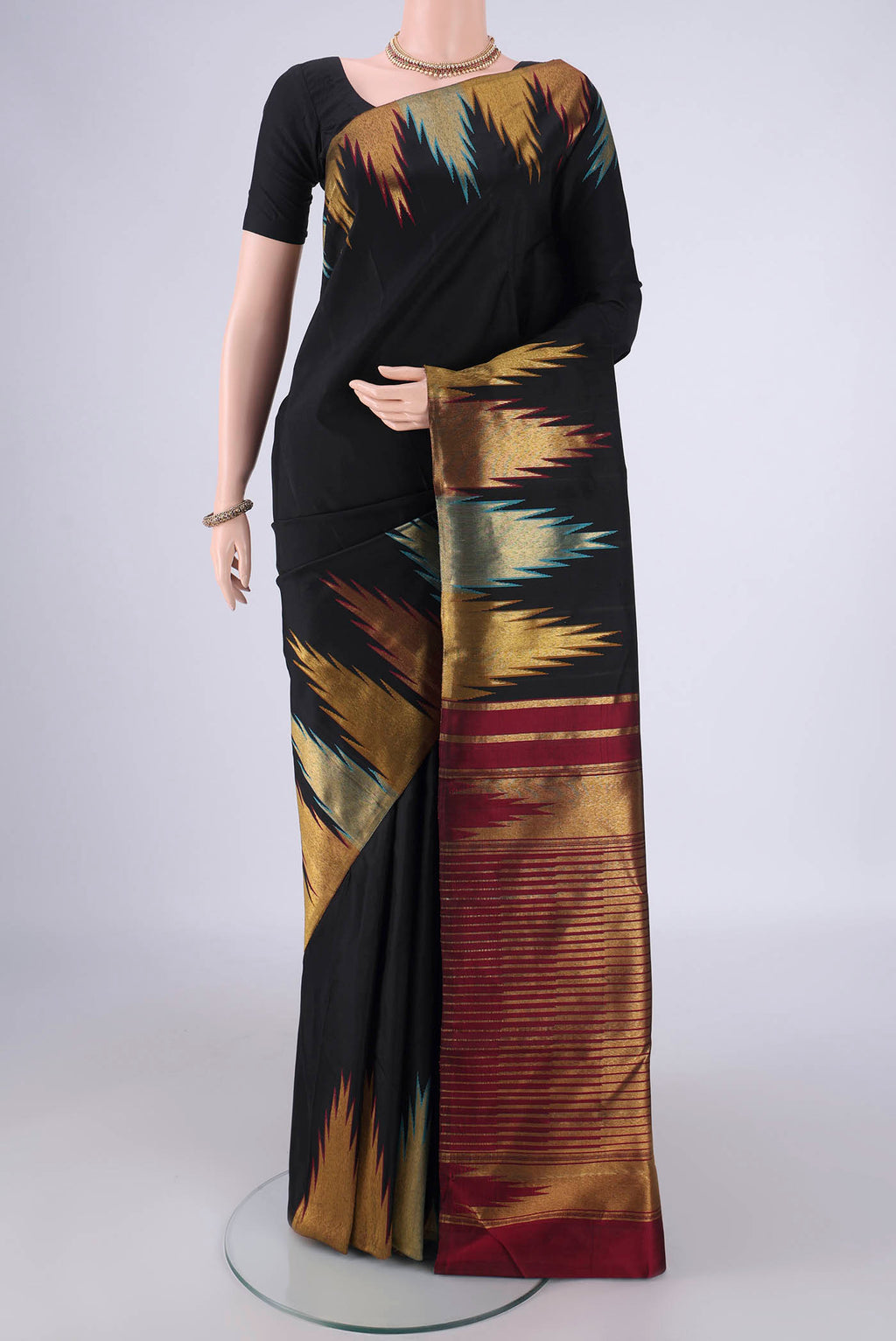 Black Kanjivaram Silk Saree with Plain Body and Temple Border.  displayed on a mannequin