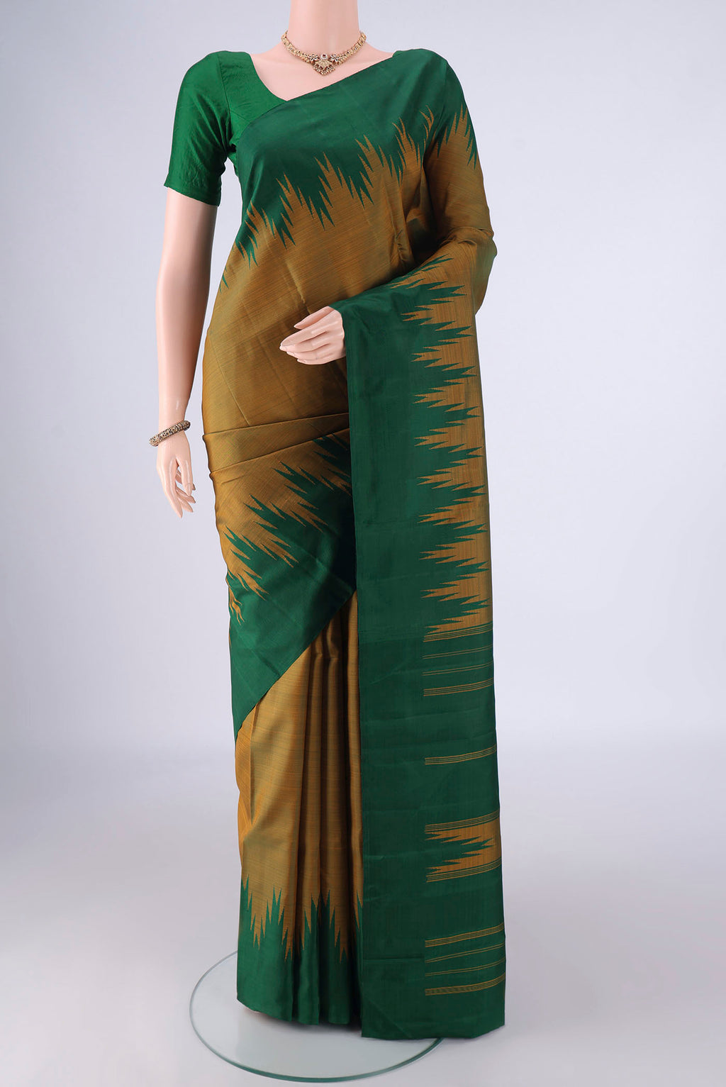 Mehandi Green Kanchipuram Silk Saree with Plain Body and Temple Border.  displayed on a mannequin
