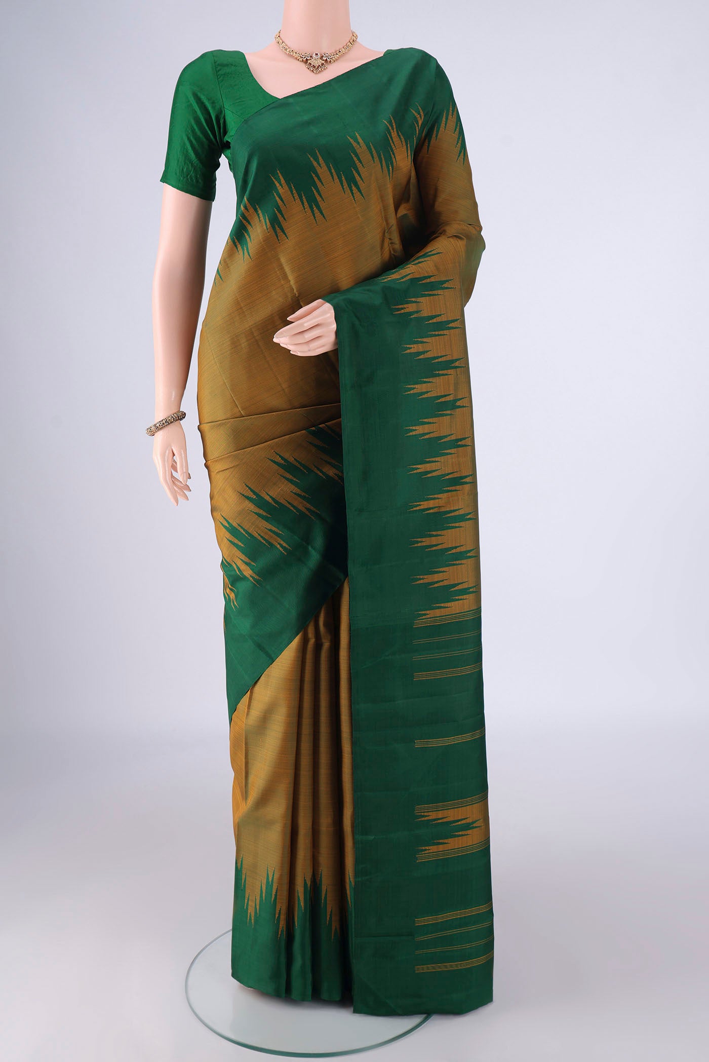Mehandi Green Kanchipuram Silk Saree with Plain Body and Temple Border.  displayed on a mannequin