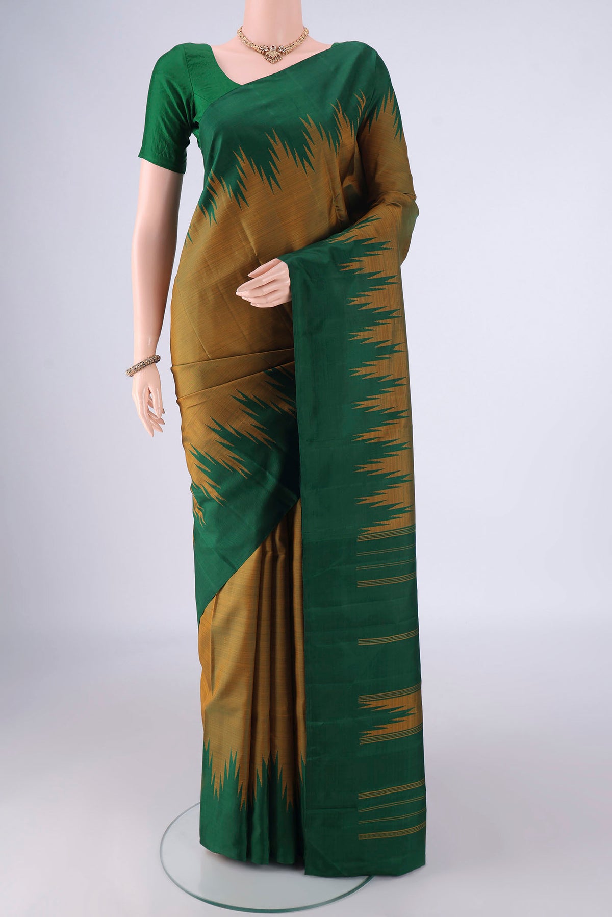 Mehandi Green Kanchipuram Silk Saree with Plain Body and Temple Border.  displayed on a mannequin