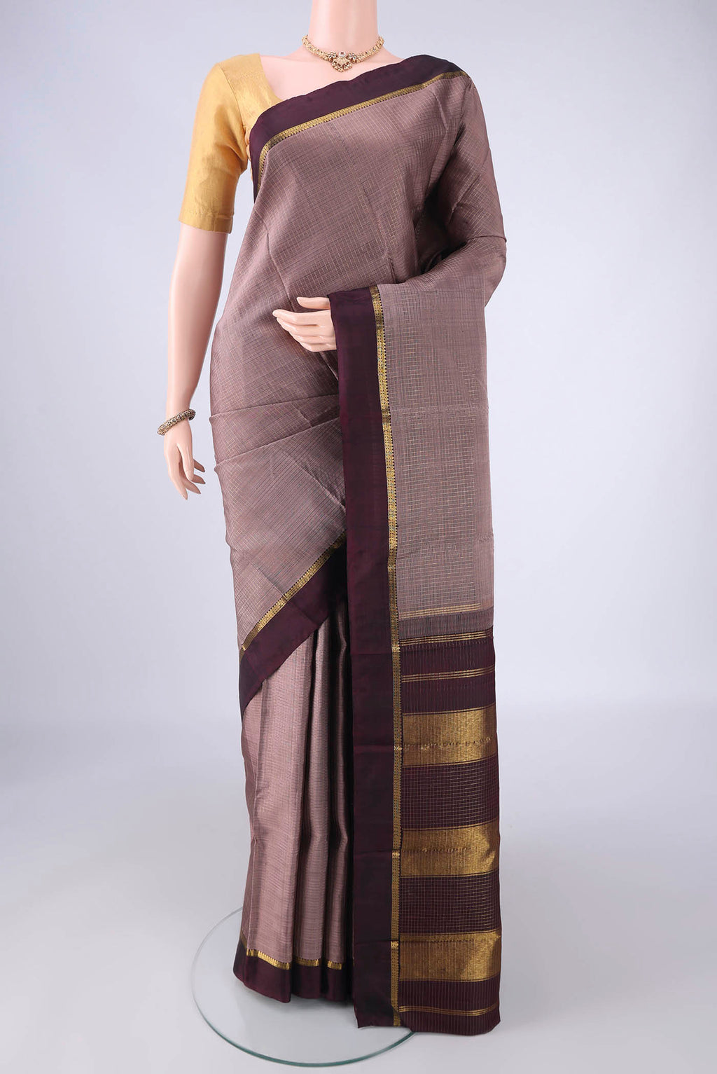 Dark Mauve Kanjivaram Silk Saree with Checked design on the body and Zari Border.  displayed on a mannequin
