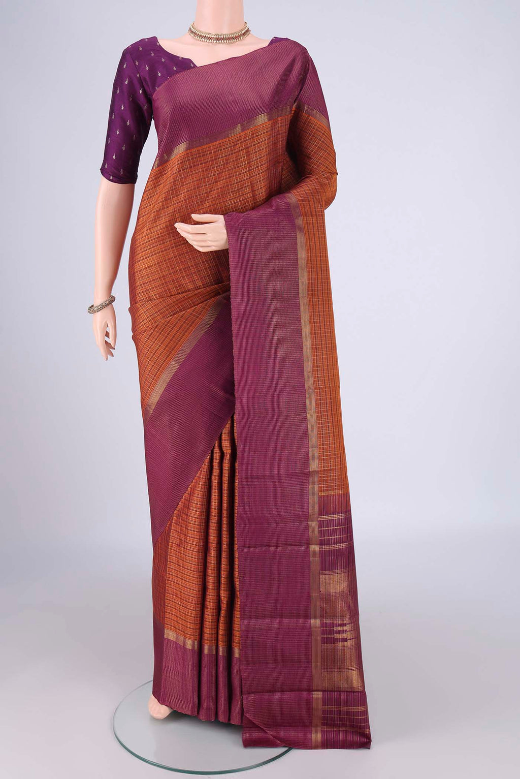 Bottle Green Kanjivaram Silk Saree with Zari Brocade on the body and Checks Border.  displayed on a mannequin
