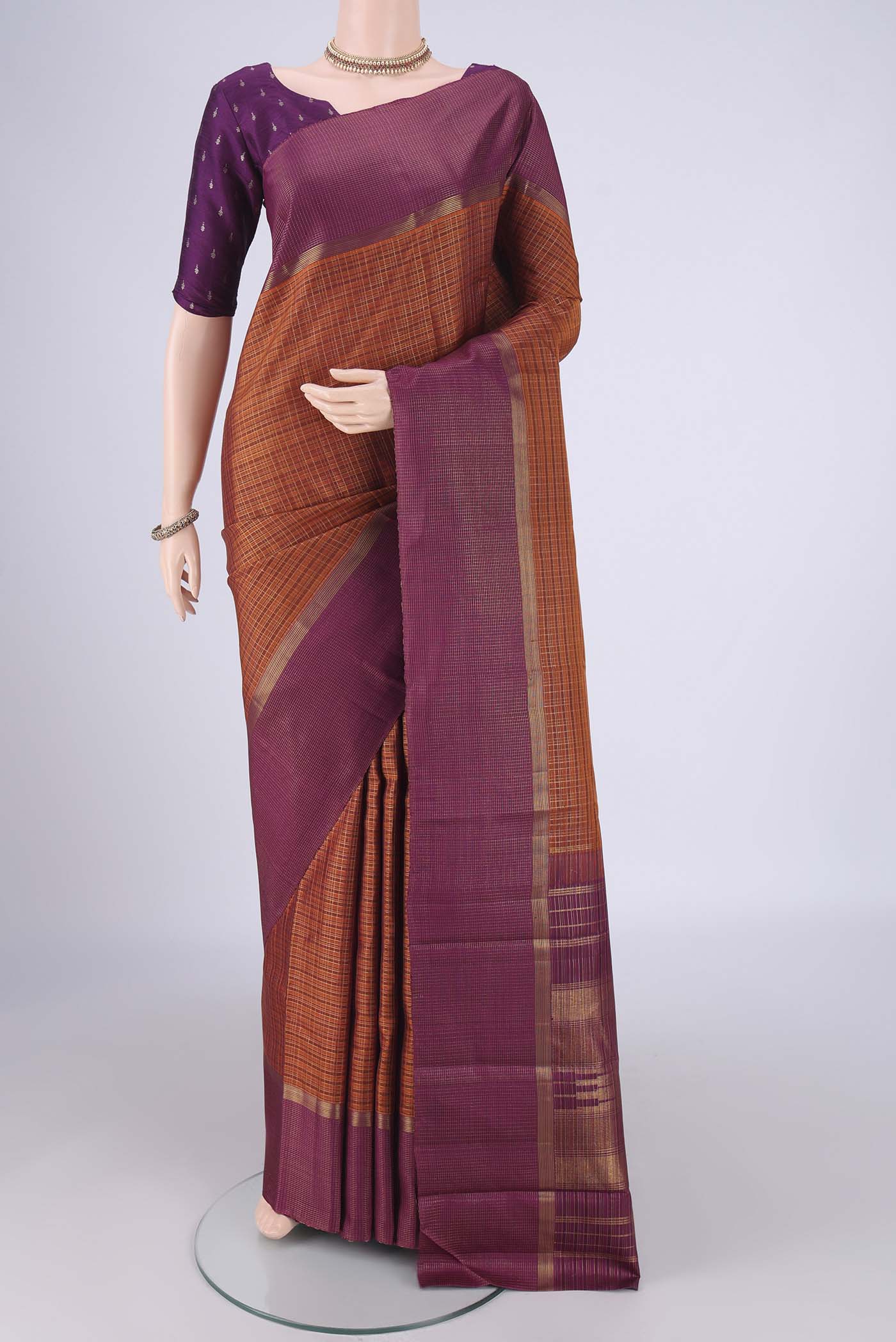 Bottle Green Kanjivaram Silk Saree with Zari Brocade on the body and Checks Border.  displayed on a mannequin