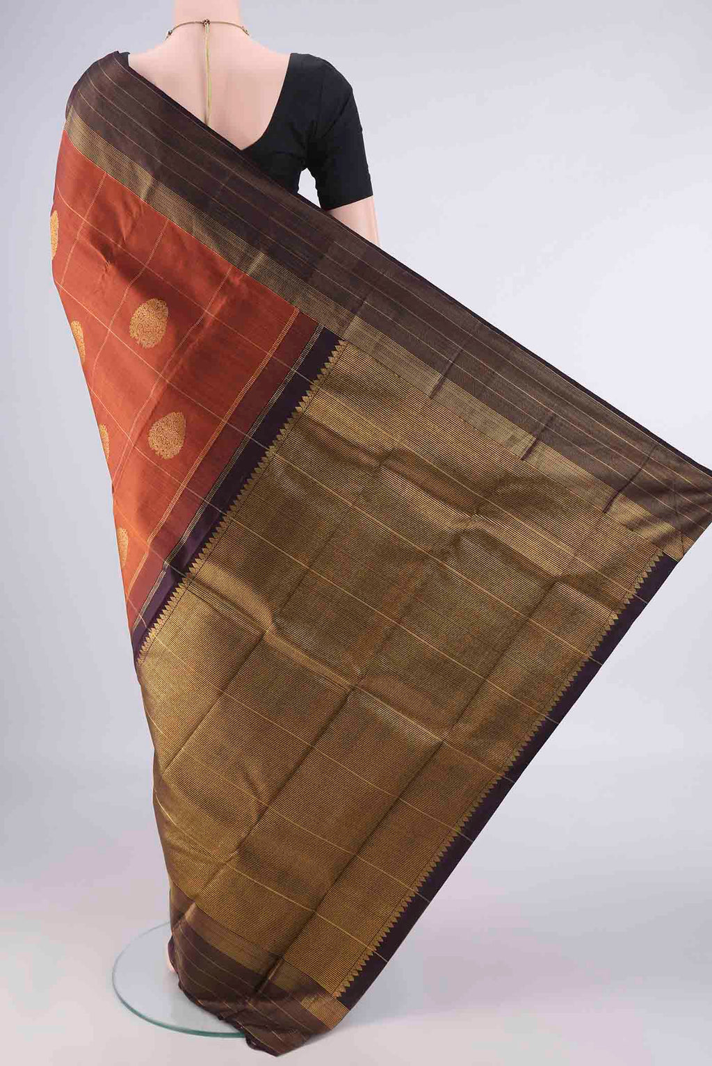 Flat view of Pure Silk Rust Kanjivaram Saree with Checked design on the body and Zari Border. 