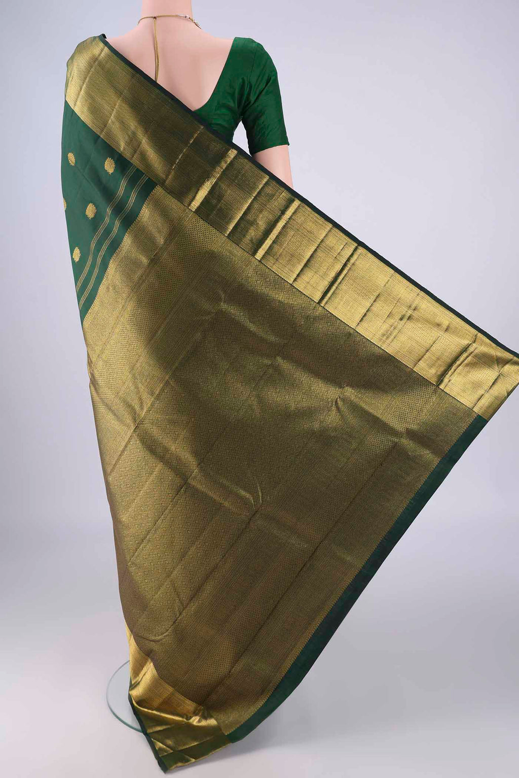 Flat view of Bottle Green Kanjivaram Silk Saree with Zari Butta on the body and Zari Border. 