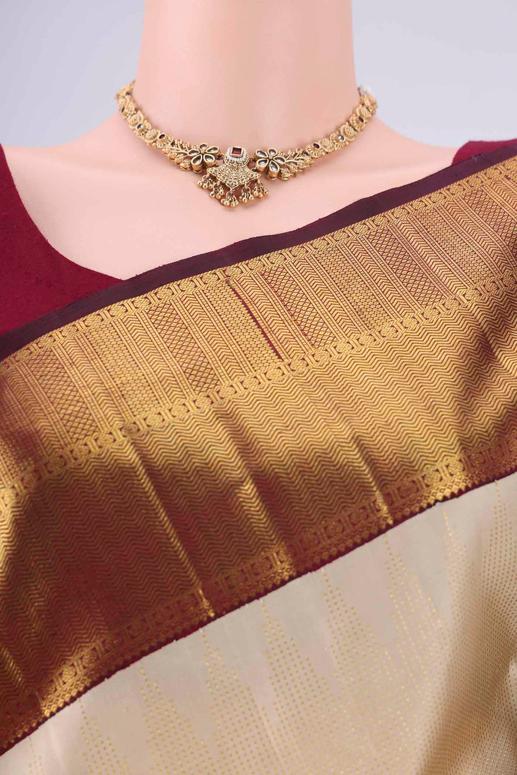 Border image of Cream Kanchipuram Silk Saree with Stripes on the body and Temple Border. 