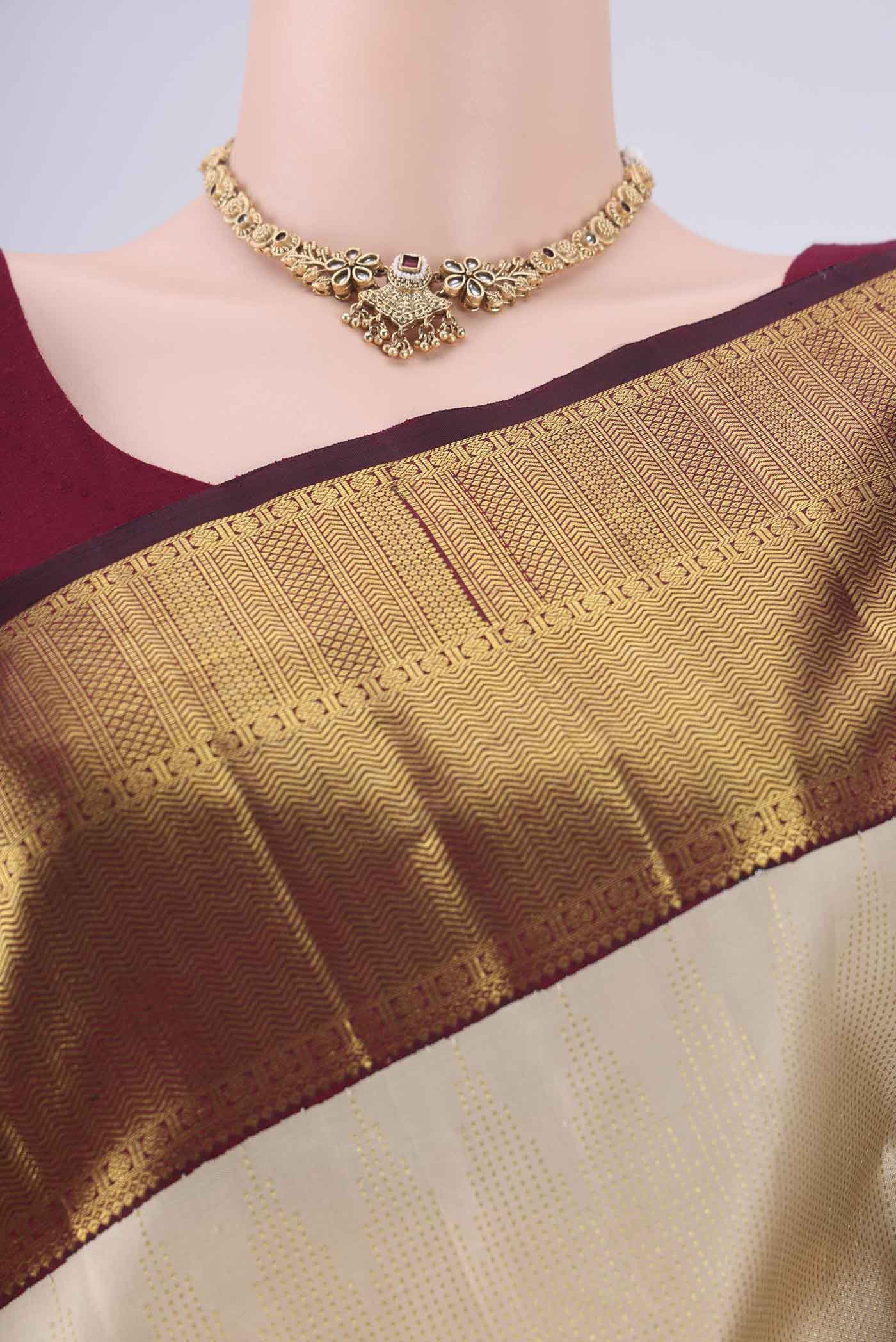 Border image of Cream Kanchipuram Silk Saree with Stripes on the body and Temple Border. 