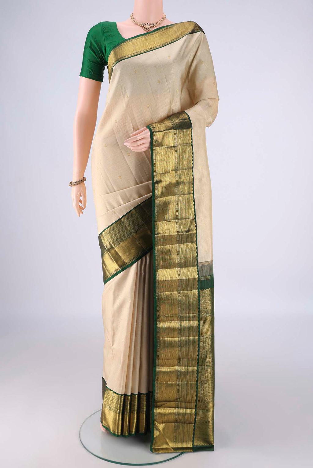 Cream Kanchipuram Silk Saree with Checked design on the body and Zari Border.  displayed on a mannequin
