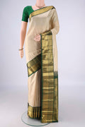 Cream Kanchipuram Silk Saree with Checked design on the body and Zari Border.  displayed on a mannequin