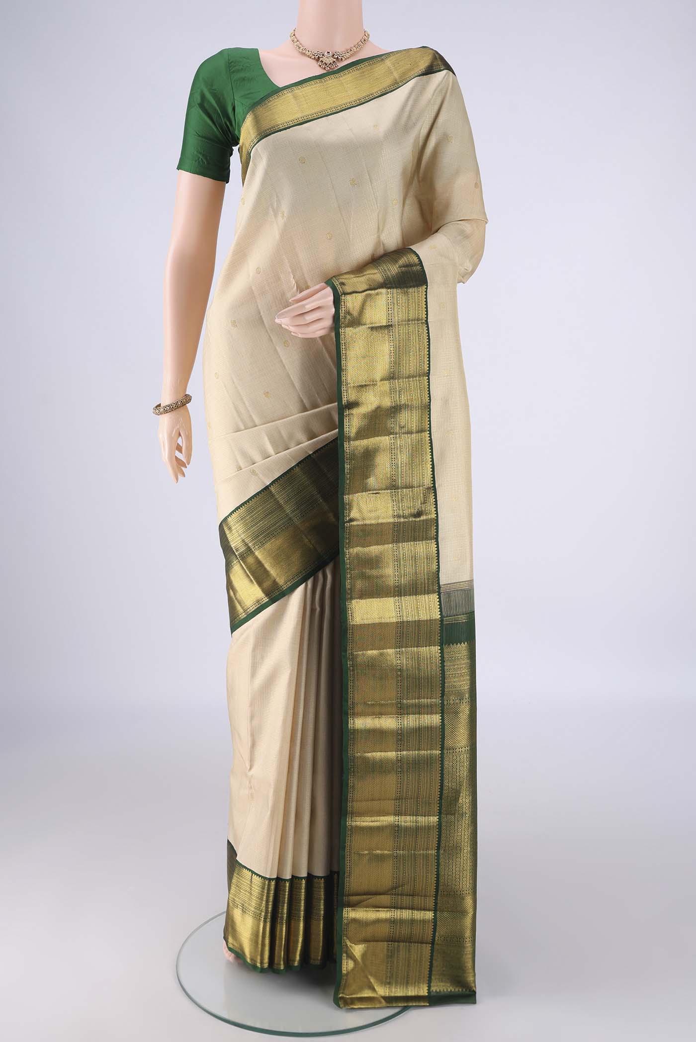 Cream Kanchipuram Silk Saree with Checked design on the body and Zari Border.  displayed on a mannequin