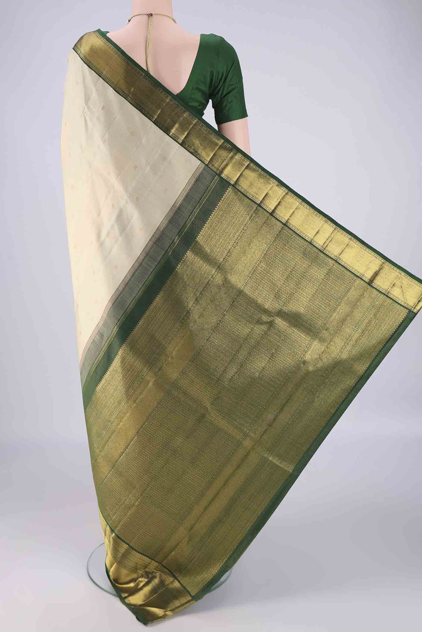 Flat view of Cream Kanchipuram Silk Saree with Checked design on the body and Zari Border. 