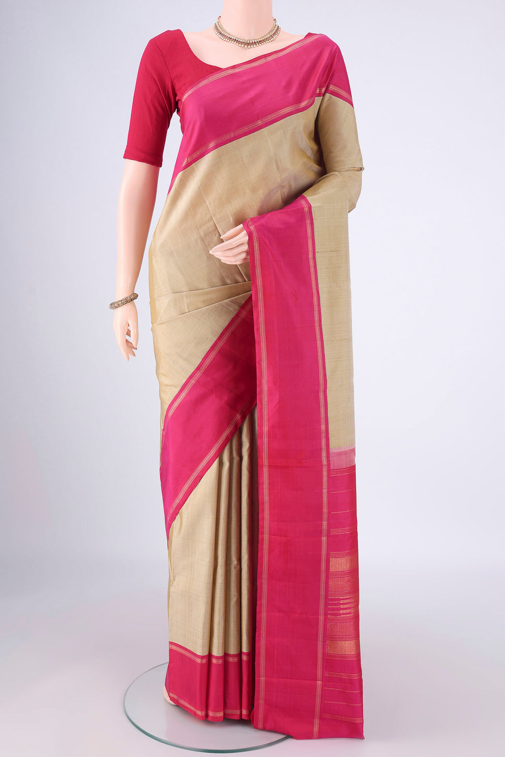 Beige Kanjivaram Silk Saree with Plain Body and Thin Zari Line.  displayed on a mannequin