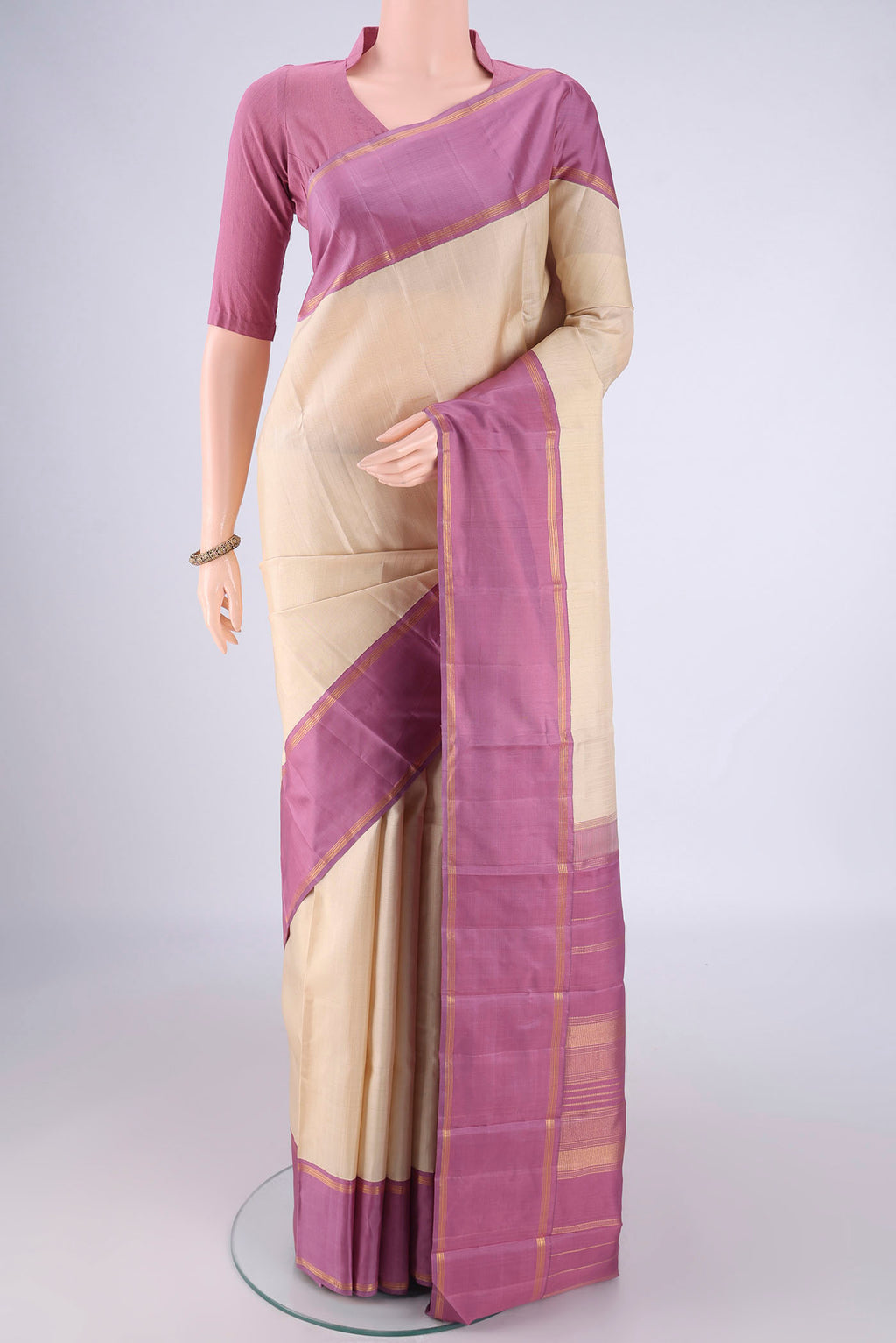 Cream Kanjivaram Silk Saree with Plain Body and Plain Border.  displayed on a mannequin