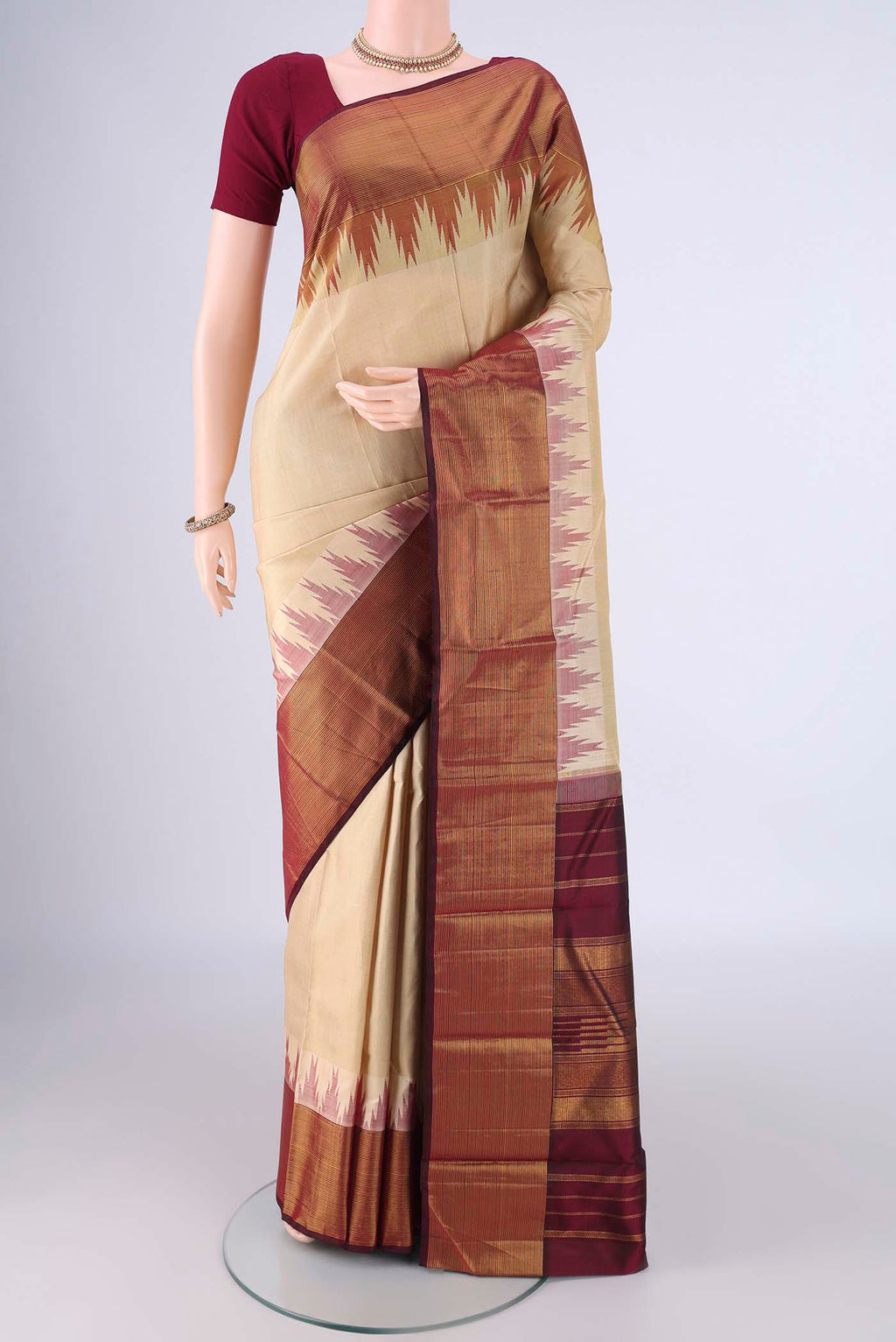 Beige Kanjivaram Silk Saree with Plain Body and Temple Border.  displayed on a mannequin