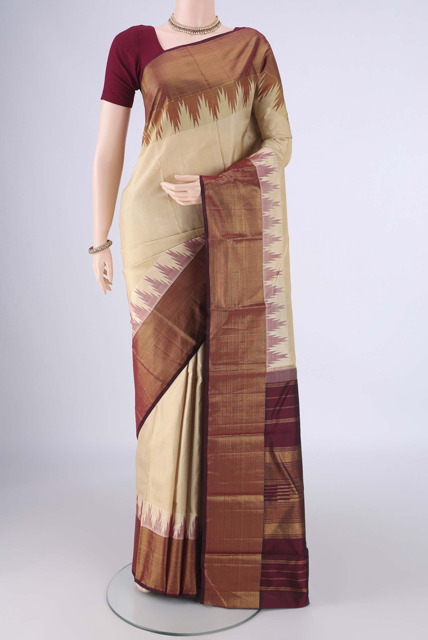 Beige Kanjivaram Silk Saree with Plain Body and Temple Border.  displayed on a mannequin