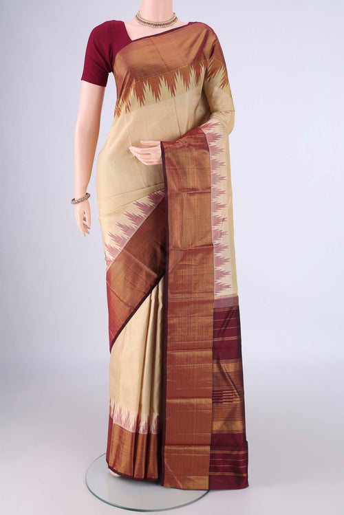 Beige Kanjivaram Silk Saree with Plain Body and Temple Border.  displayed on a mannequin