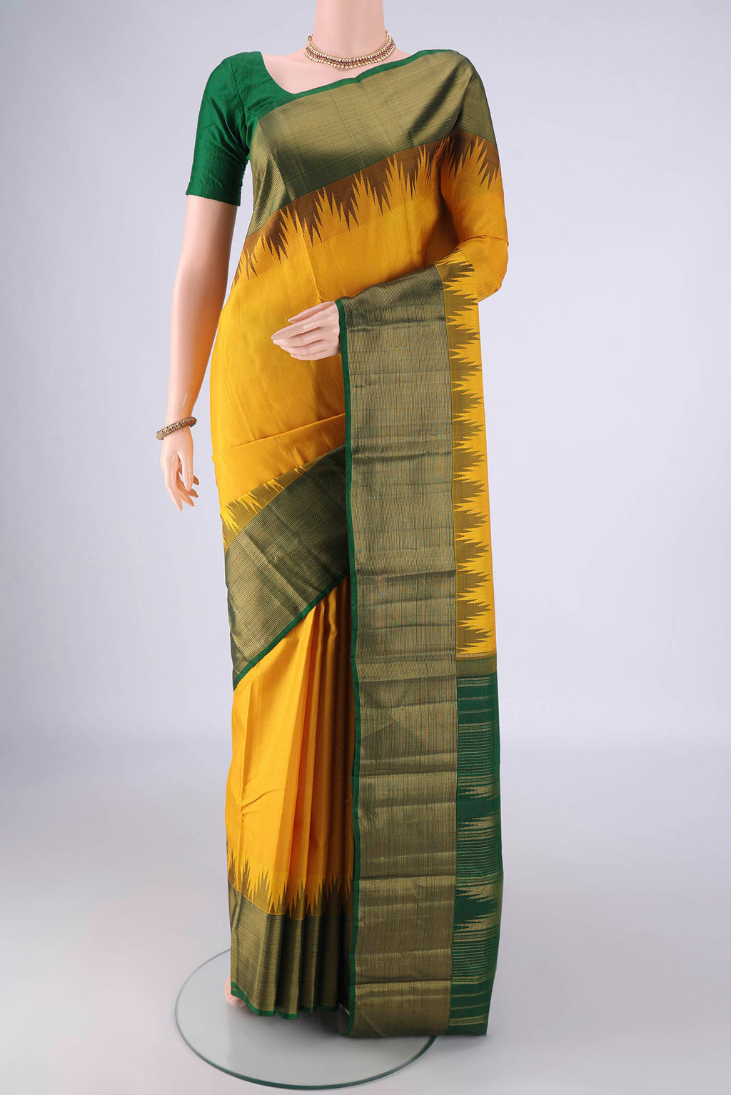 Yellow Kanjivaram Silk Saree with Plain Body and Temple Border.  displayed on a mannequin