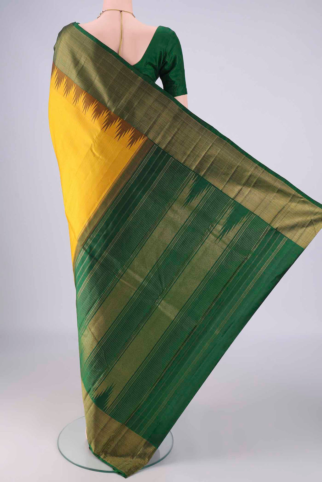 Flat view of Yellow Kanjivaram Silk Saree with Plain Body and Temple Border. 