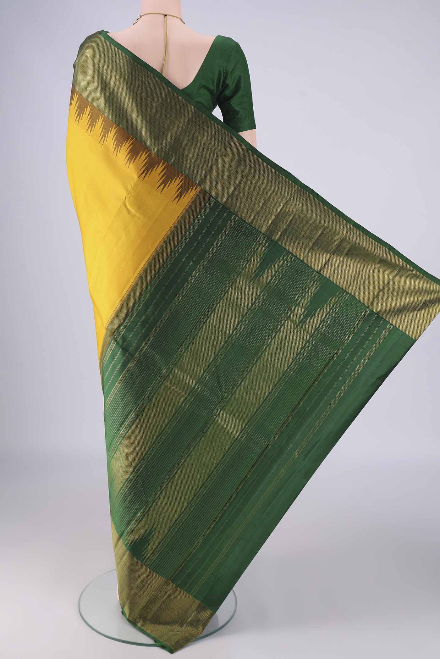 Flat view of Yellow Kanjivaram Silk Saree with Plain Body and Temple Border. 