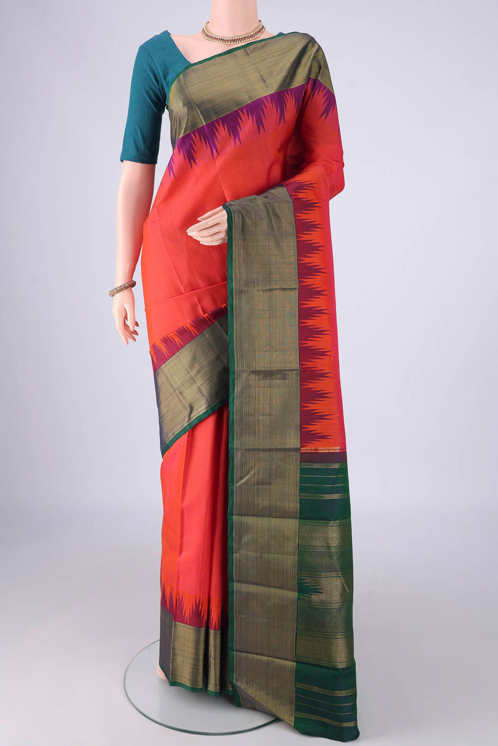 Brick Orange Dual Tone Kanjivaram Silk Saree with Plain Body and Temple Border.  displayed on a mannequin