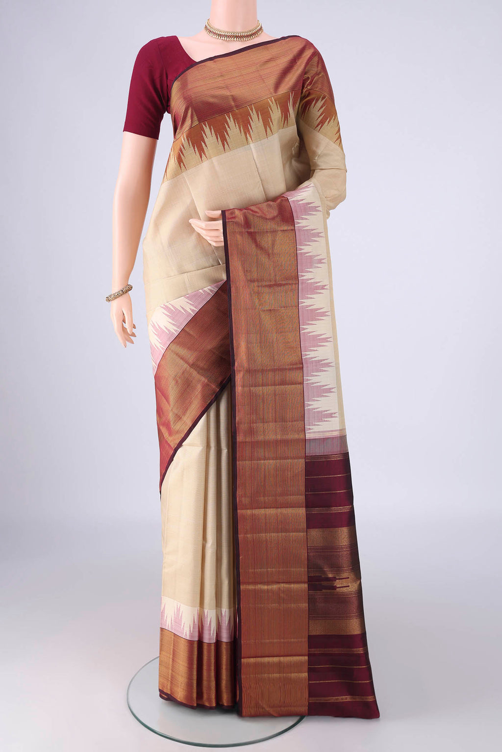 Cream Kanjivaram Silk Saree with Plain Body and Temple Border.  displayed on a mannequin