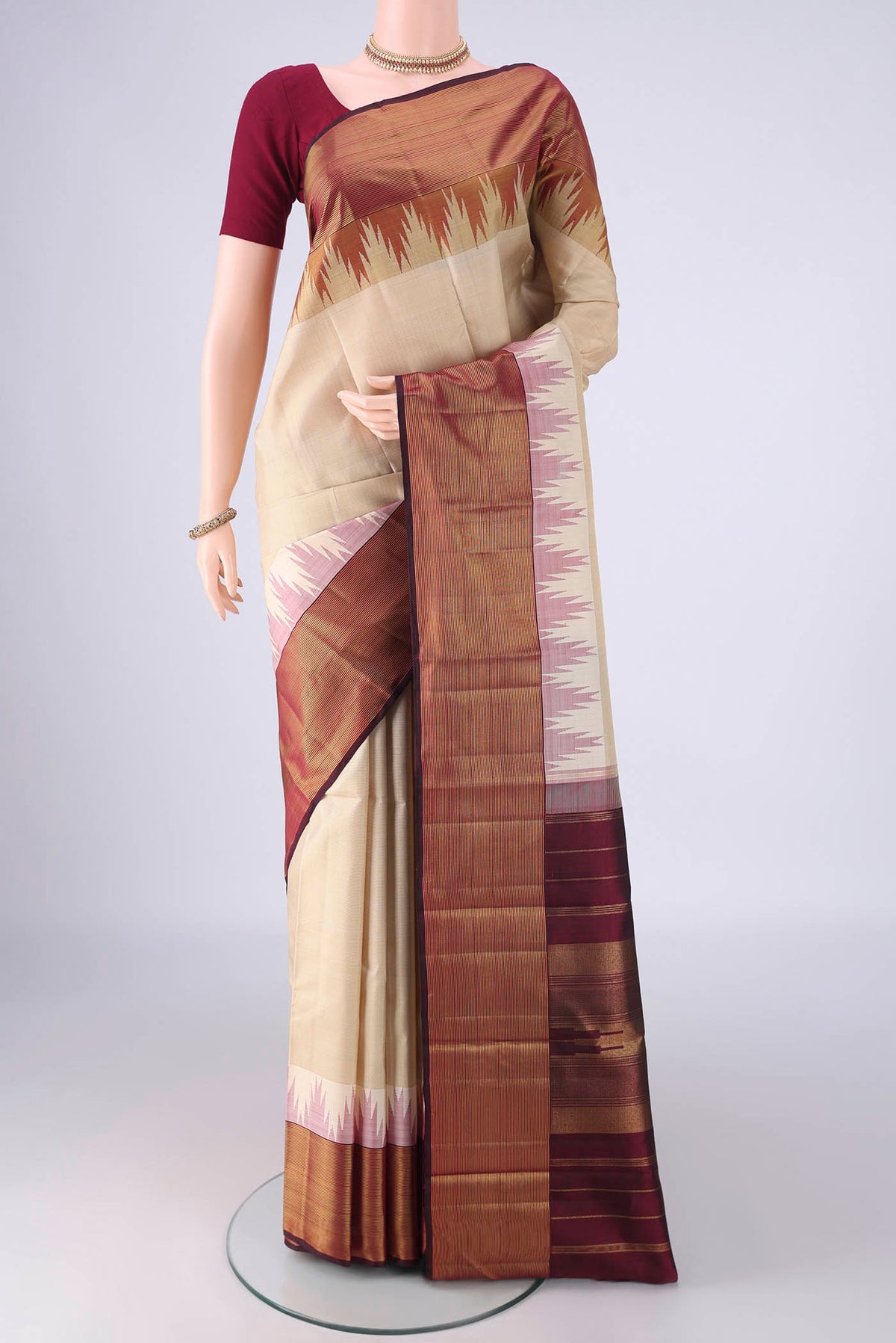 Cream Kanjivaram Silk Saree with Plain Body and Temple Border.  displayed on a mannequin