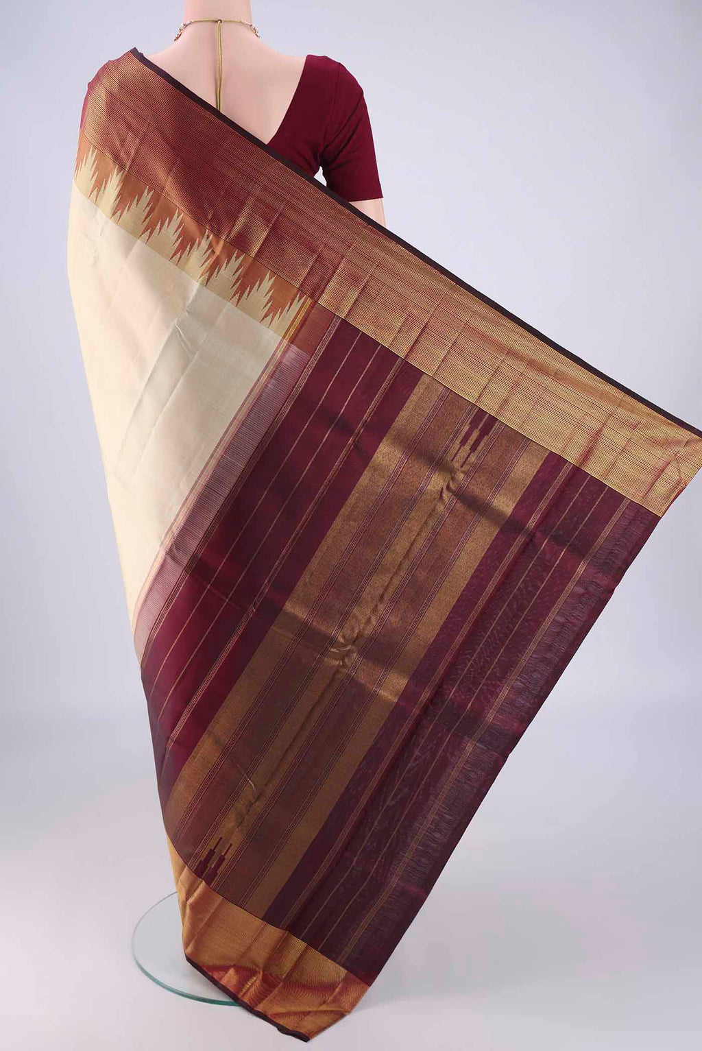 Flat view of Cream Kanjivaram Silk Saree with Plain Body and Temple Border. 