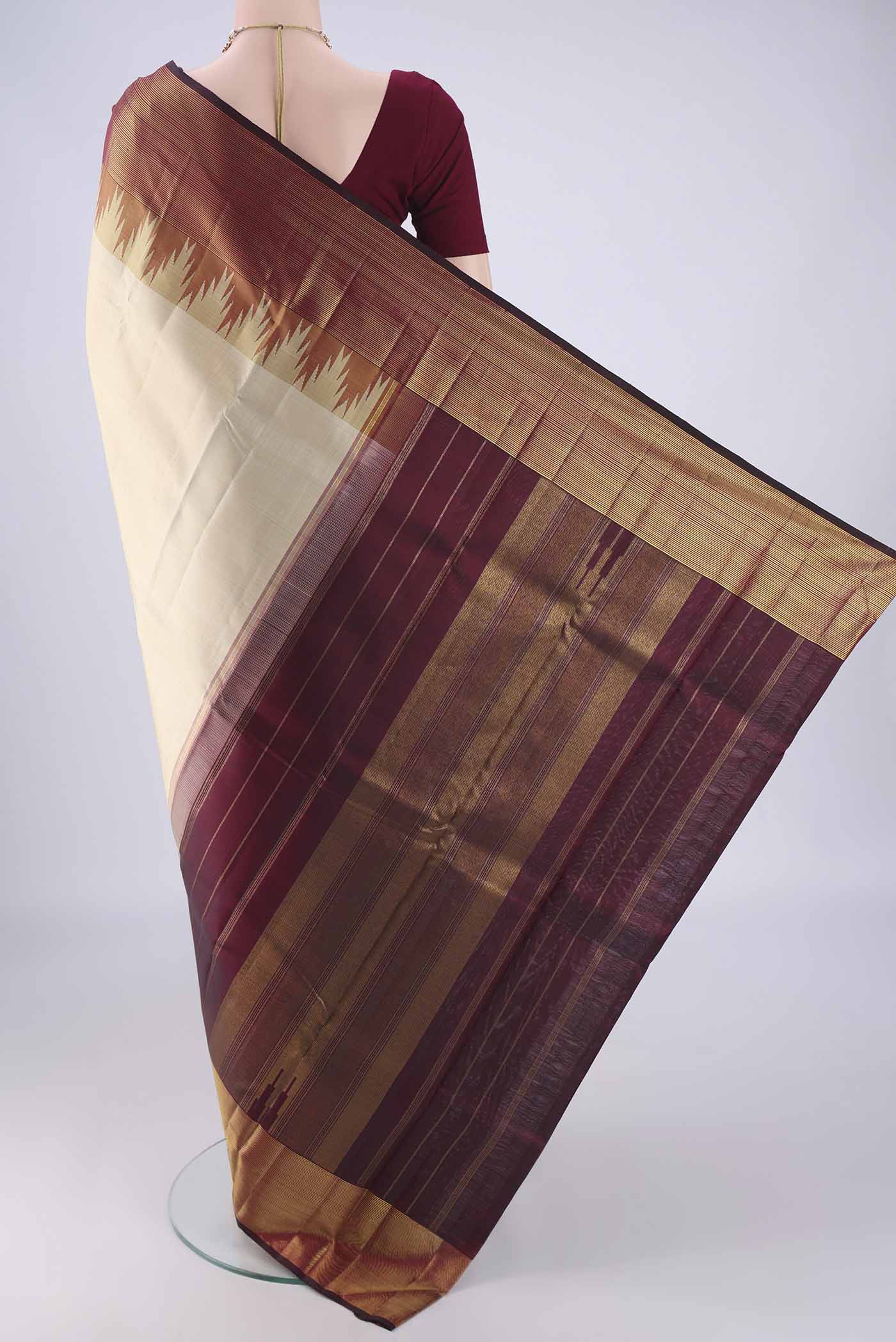 Flat view of Cream Kanjivaram Silk Saree with Plain Body and Temple Border. 